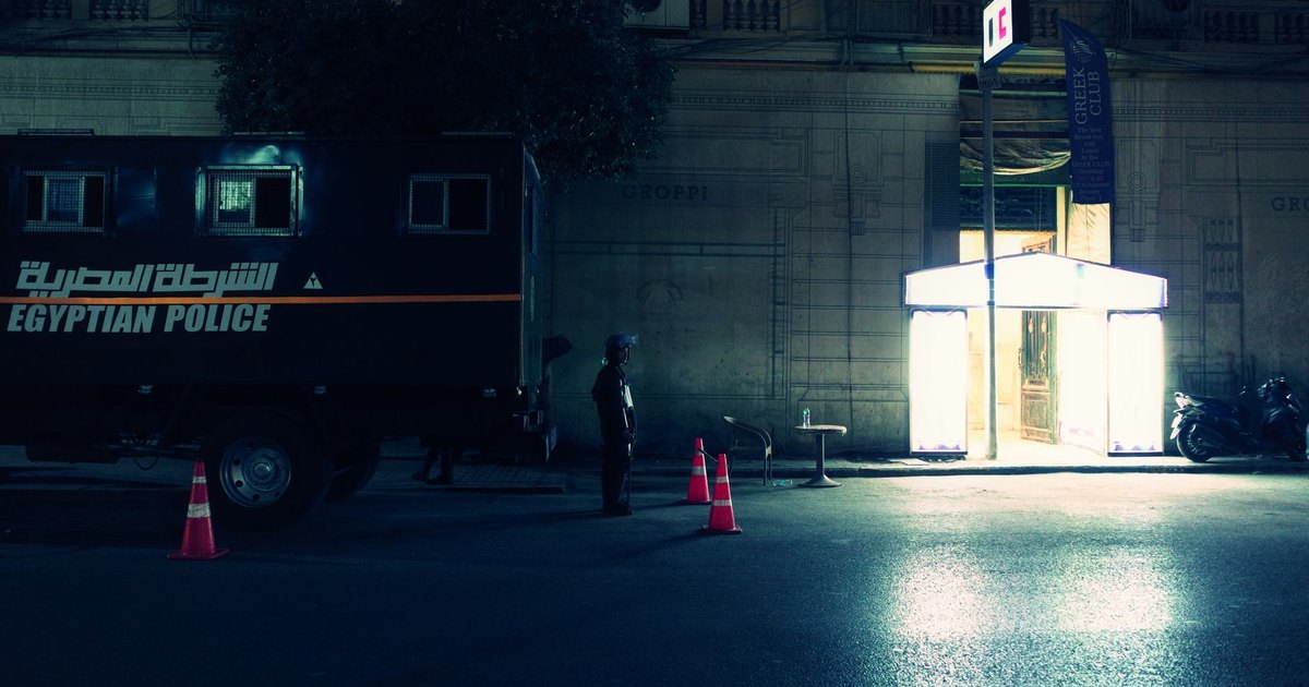Police tape cordons off a street at night