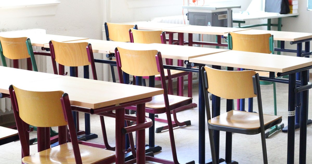 Empty classroom with rows of wooden desks