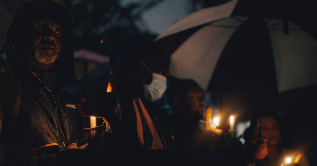 A smartphone showing a social media profile in dim light