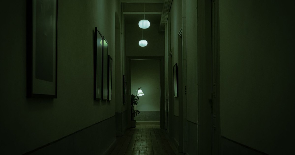 A smartphone screen glowing with social media apps in a darkened room