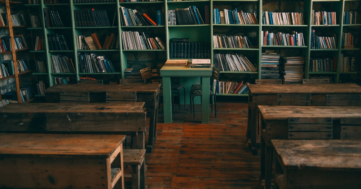 An empty rural classroom with wooden desks